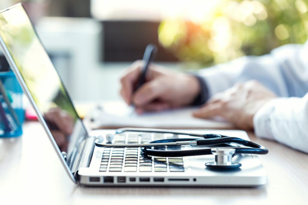 Medical stethoscope on laptop keyboard.